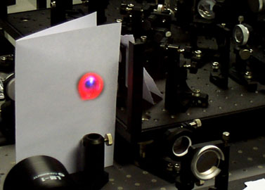 Optical breakdown in air by the focused femtosecond pulses is accompanied by the nonlinear optical effects leading to spectral broadening and harmonic generation.